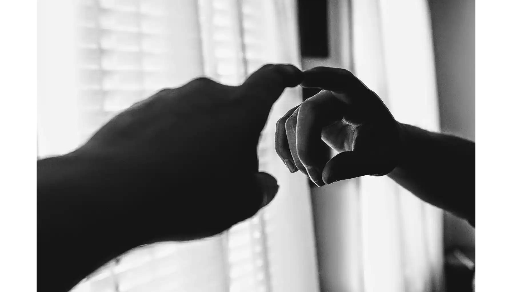 men's hand touching the mirror reflection