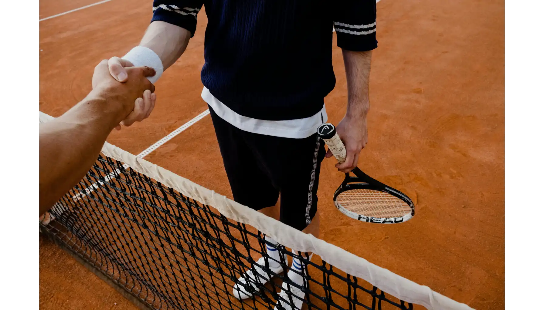 two tennis players shake hands